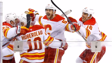 Calgary Flames players celebrate a goal on the road.